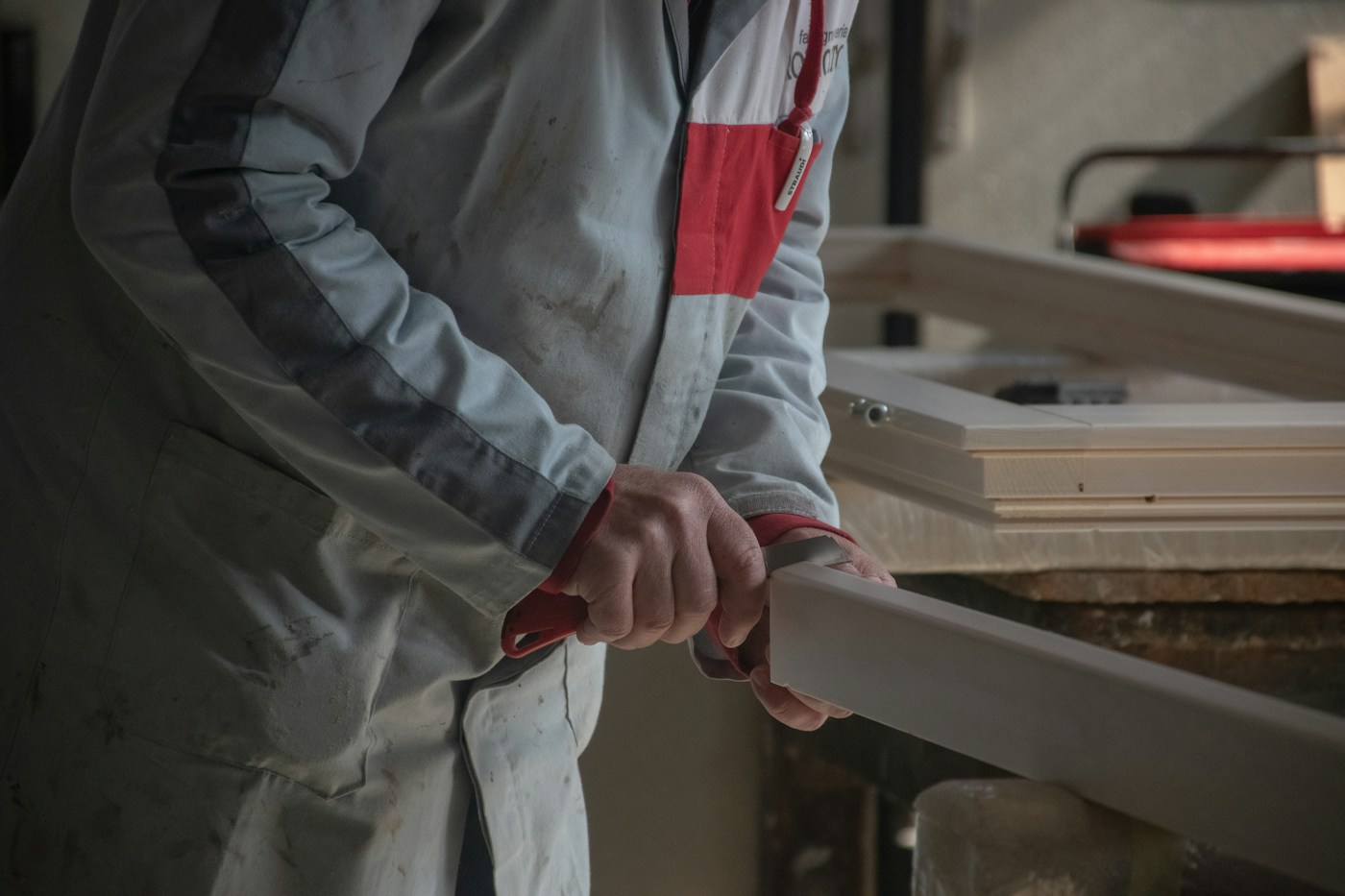 A craftsperson shaping a component at a workbench