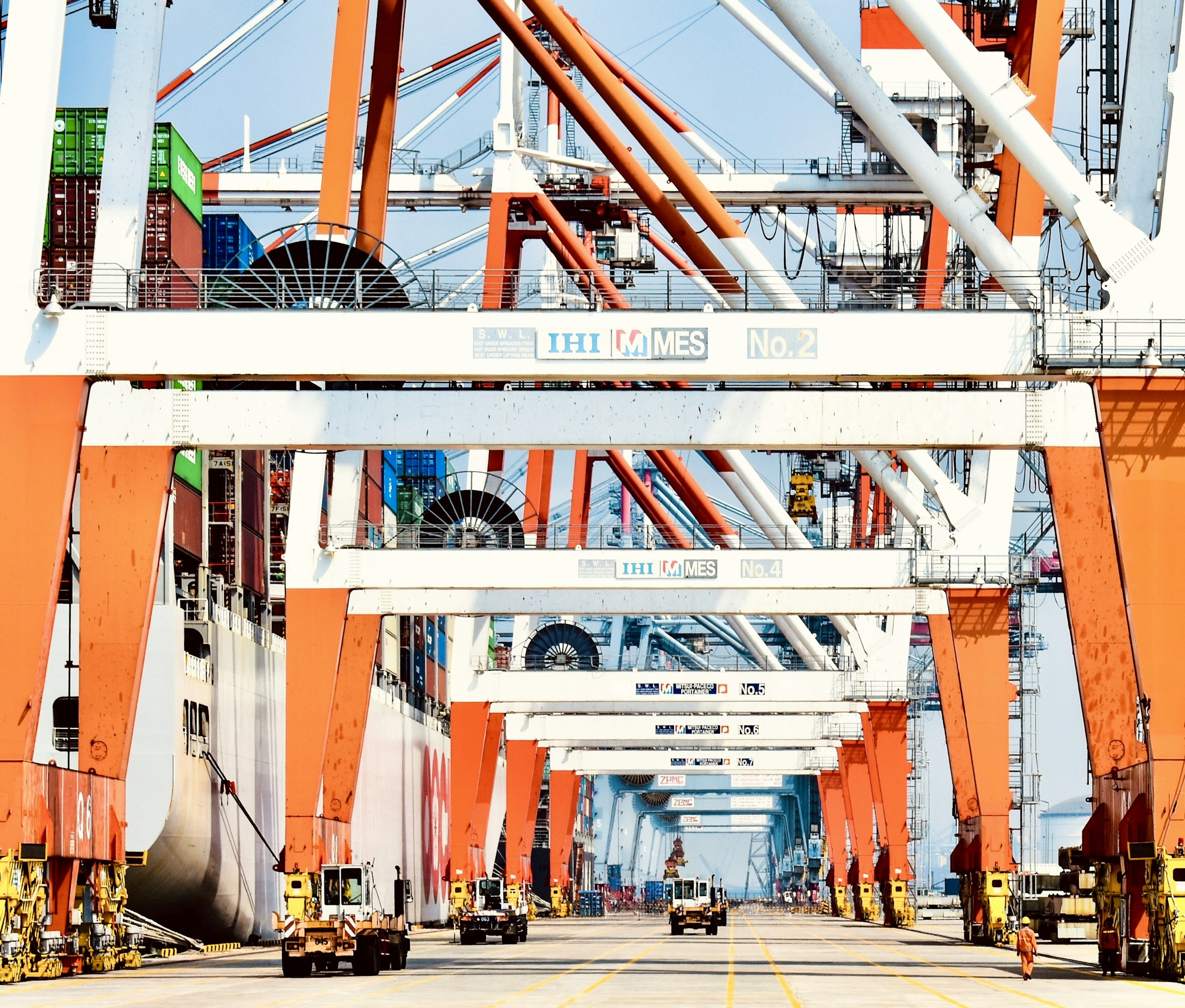Gantry cranes and stacked containers at a working cargo terminal