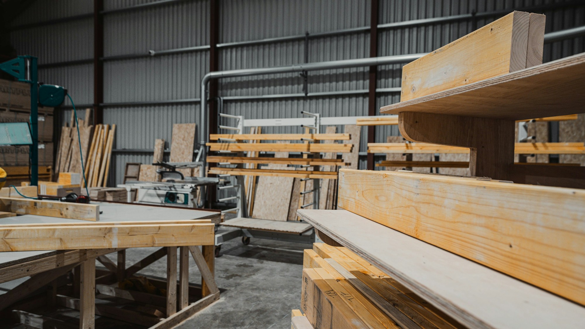 Timber beams and plywood sheets in a working joinery workshop